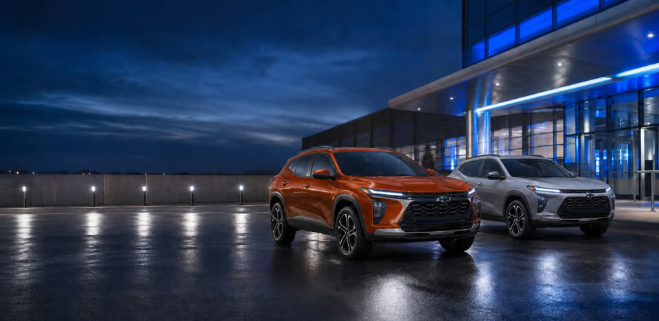 Two Chevrolet Trax SUVs ready for guests at a modern airport setting